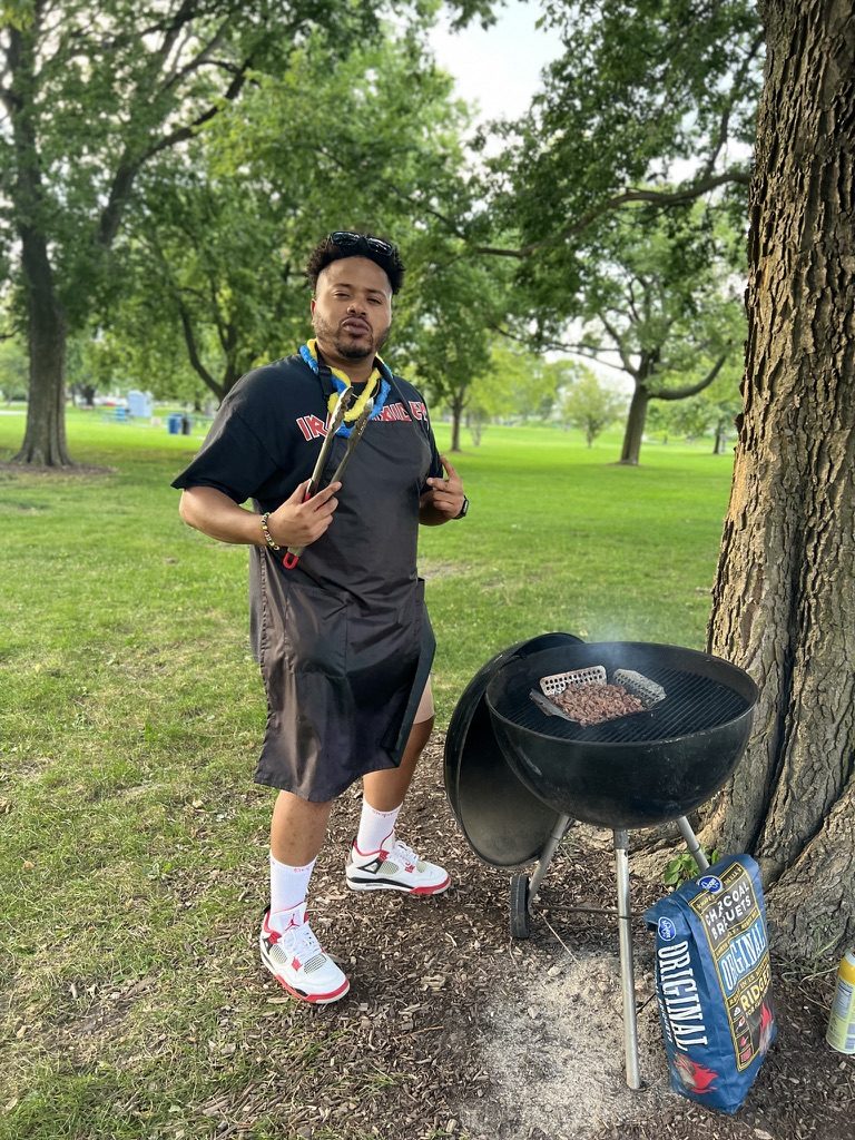 Otis Campbell, owner of Campbell Grill Detail, grilling on a Weber kettle in a park